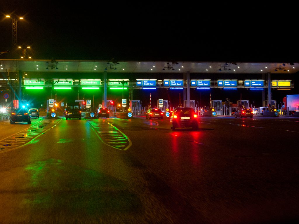 Toll plaza lanes at night as a confidence gate